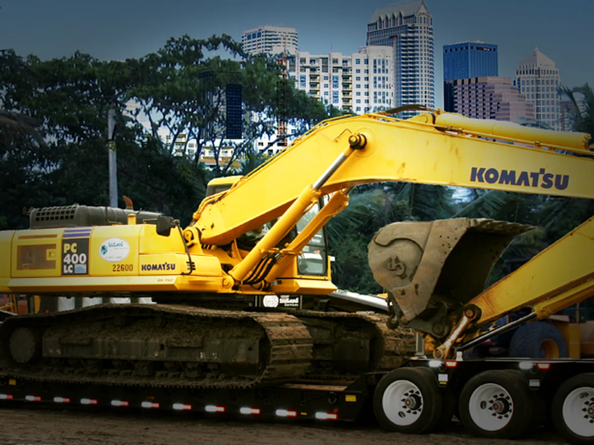 Lowboy trailer hauling construction equipment